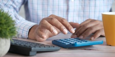 Person using calculator at a desk.